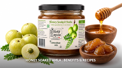 Honey and Spice jar of honey-soaked amla with fresh Indian gooseberries and a raw honey dipper.
