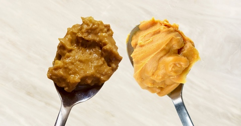 Close-up of creamy and crunchy peanut butter on separate spoons, highlighting the smooth texture of creamy peanut butter and the chunky, nut-filled consistency of crunchy peanut butter for showing the difference between creamy and crunchy peanut butter