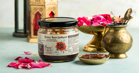 Jar of Honey Rose Gulkand by Honey and Spice with fresh rose petals and traditional decor, representing the ancient Ayurvedic remedy highlighted in the blog 'The Real Benefits of Gulkand: Ancient Remedy Backed by Science.