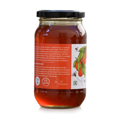 Back view of a wild berry honey jar 500g. showcasing its label with product details, origin, and 100% raw, natural.