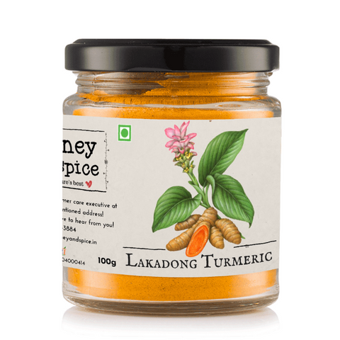 Lakadong Turmeric powder in a glass jar 100g with vibrant yellow contents and botanical artwork.