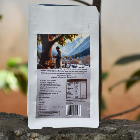 Back view of Kashmiri Walnuts pack with nutrition label and mountain artwork.
