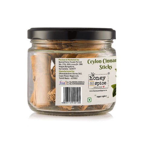 Side view of a glass jar of Ceylon Cinnamon Sticks showing product branding and partial details.