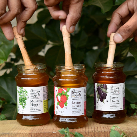 Honey jars with dipper – Tulsi, Litchi, and Jamun honey in natural setting