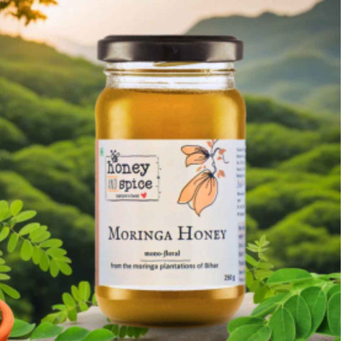 Moringa Honey jar placed in lush green moringa field – natural honey source