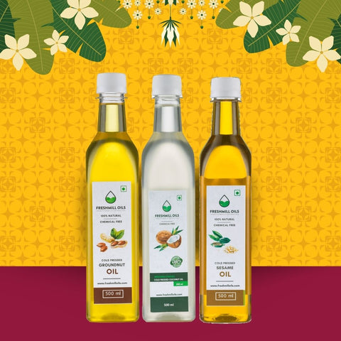 Set of natural cooking oils – groundnut, coconut, and sesame oil bottles on festive yellow backdrop