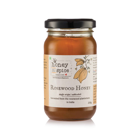 Angled front view of Rosewood Honey jar with label visible