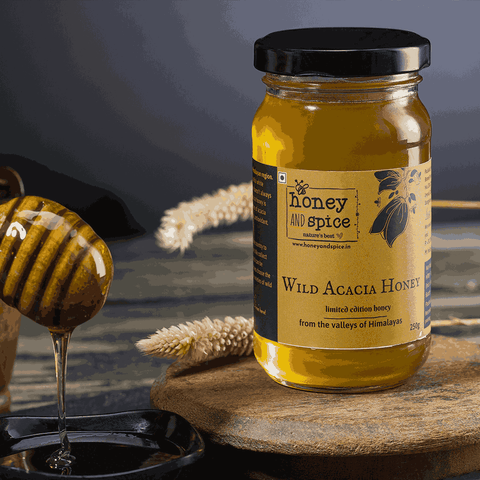 Wild Acacia Honey being drizzled from dipper into jar – pure raw Himalayan honey