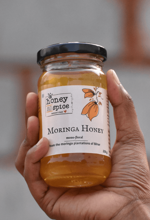 Person holding Moringa Honey jar – portable and eco-friendly packaging