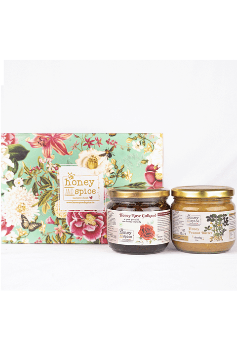 Festive gift box with Honey Rose Gulkand and Forest Honey jars on white background