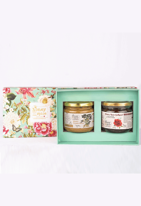 Opened floral gift box with Honey Rose Gulkand and Forest Honey jars for Raksha Bandhan