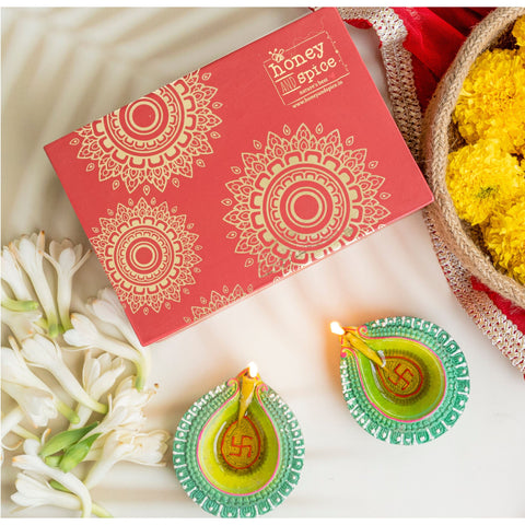 Decorative gift box with traditional diyas and flowers