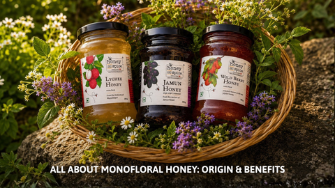Bowls of different colored raw monofloral honey with fresh honeycomb and natural flowers