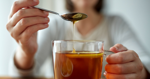 honey from honey and spice in a bowl with a honey dipper