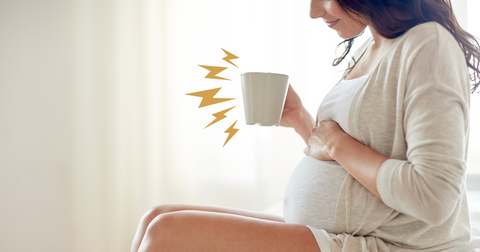 A smiling pregnant woman enjoying a cup of green tea, symbolizing its calming and soothing effects during pregnancy. This image visually represents the potential benefits of green tea, such as stress relief and improved digestion, as discussed in the blog